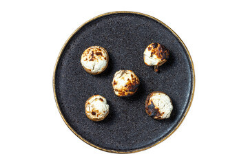 top view of stuffed mushrooms on a plate with black texture and golden edges.