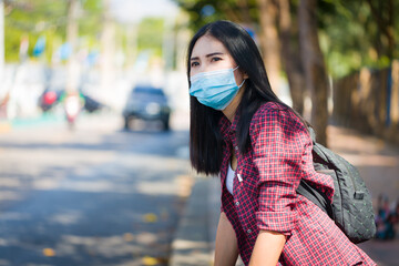 Asian woman wearing a mask on the streets of the city.