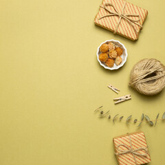Gift boxes with dry flowers on khaki background. flat lay, top view, copy space