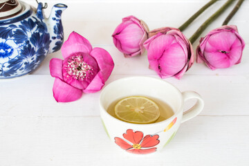 mix honey lemon herbal hot healthy drinks for sore throat with lemon slice and pink flower lotus on background white