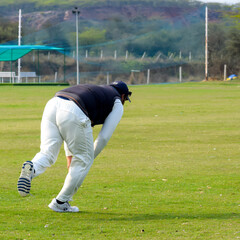New Delhi India – July 01 2018 : Full length of cricketer playing on field during sunny day in...