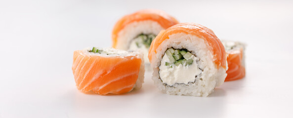 Philadelphia roll sushi on a white plate. Isolated. Restaurant concept. Close-up.