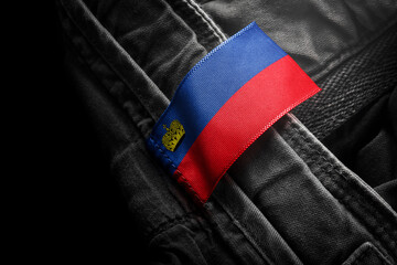 Tag on dark clothing in the form of the flag of the Liechtenstein