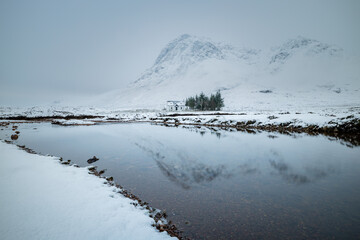 the majestic buachaille etive mor on rannoch moor and glencoe in the argyll region of the highlands of scotland during a snow storm in winter