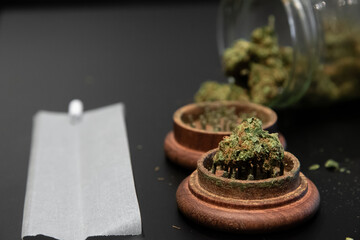 Cannabis buds, a joint and other smoking utensils