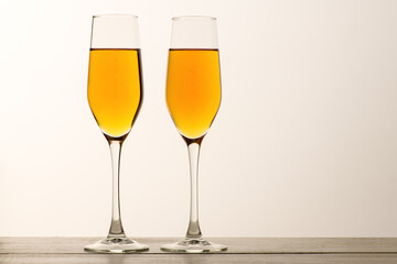 Two glasses of champagne, wine with bubbles on gray background. Alcoholic drink: champagne, beer, white wine. New year and Christmas background. Valentine's Day. Vertical