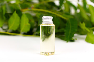 neem oil in bottle and neem leaf isolate on white background.