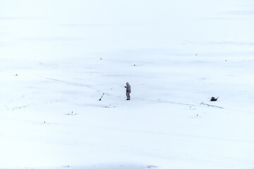 Fisherman on the ice of a frozen river.