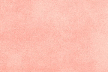 Light pink matte background of suede fabric, closeup. Velvet texture of textile
