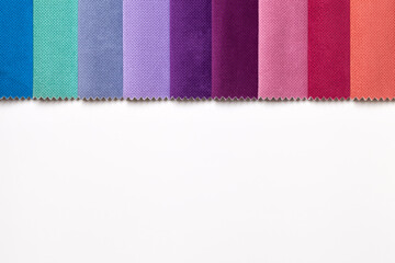Fototapeta premium Sample of velvet textile various colors, background on white table with space.