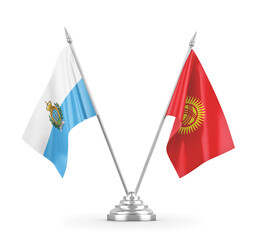 Kyrgyzstan and San Marino table flags isolated on white 3D rendering