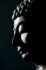 Face of buddha close up black scene