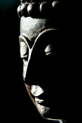 Face of buddha close up black scene