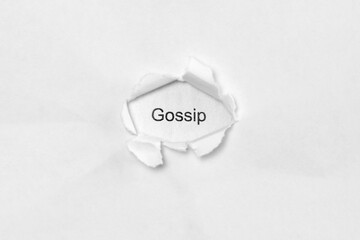 Word gossip on white isolated background, the inscription through the wound hole in paper. Concept of gender identity and sexual minorities. Stock photo for web and print with empty space for text