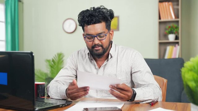 Young man reading paper letter feeling overjoyed by good news clenched fist - Concept of new Job offer or promotion, college admission and loan approvel.