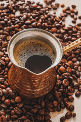 Cezve with coffee on table