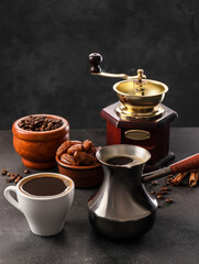 Obraz na płótnie Canvas Cezve, grinder and cup of coffee on table