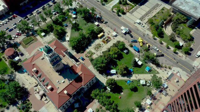 Aerial drone view of downtown Colorado Springs museum with clock tower during festival