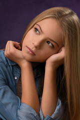 portrait of a beautiful blonde teen girl in denim shirt