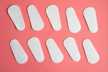 pure empty women's disposable daily menstrual sanitary pads or napkins pattern on pink background
