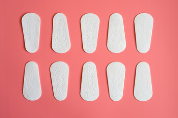 pure empty women's disposable daily menstrual sanitary pads or napkins pattern on pink background