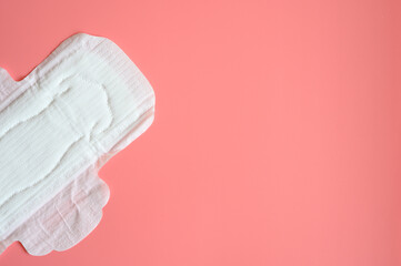 pure empty women's disposable menstrual sanitary pad or napkin for normal abundance of secretions on pink background