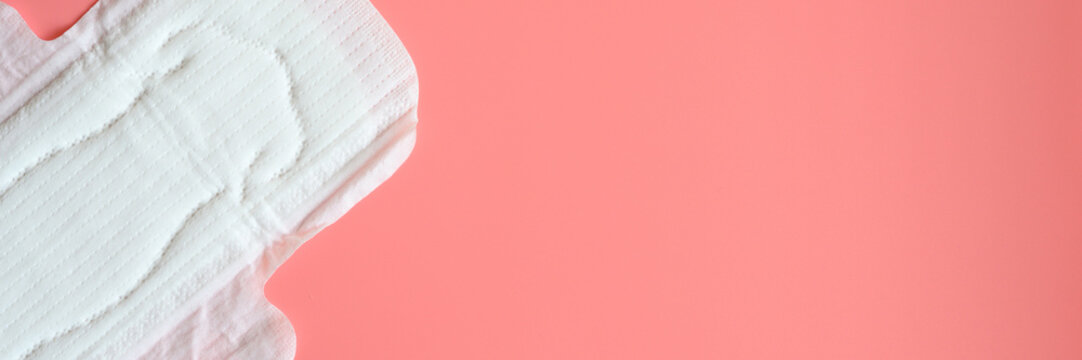pure empty women's disposable menstrual sanitary pad or napkin for normal abundance of secretions on pink background. banner