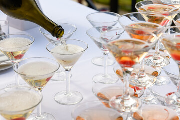 Champagne slide. Pyramid or fountain made of champagne glasses with cherry and steam from dry ice