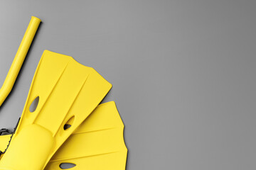 Yellow diving flippers on gray background top view © fotofabrika