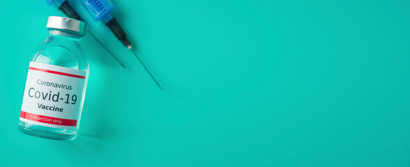 A single bottle vial of Covid-19 vaccine. Medical concept vaccination hypodermic injection...