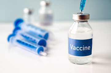A single bottle vial of Covid-19 vaccine. Medical concept vaccination hypodermic injection...