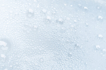 Background of soap foam and bubbles on a white background, macro photography
