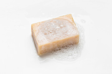 Soap bar and foam on white background, top view. Mockup for design