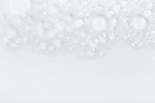 Background of soap foam and bubbles on a white background, macro photography