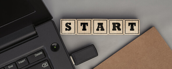 The word START made from wooden cubes. Top view