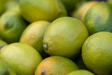 Fresh yellow green lemons at the city market