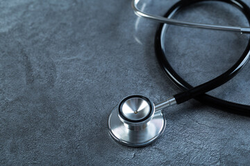 black stethoscope for medical examination on medical laboratory health table background