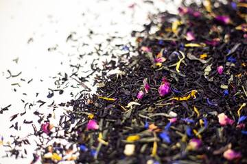 Black tea with rose petals. On a white background.
