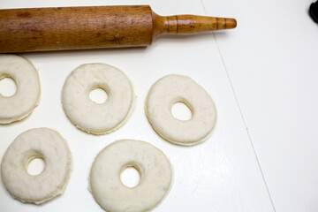 Dough prepared for homemade donuts. White background.