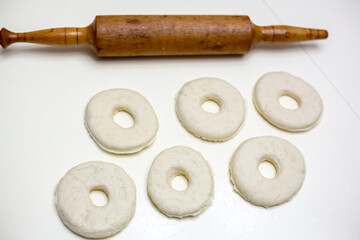 Dough prepared for homemade donuts. White background.