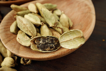 Сardamom spice bunch on wooden table macro