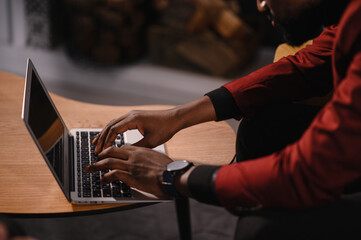 Male african american user hands typing on laptop keyboard sit at table, mixed race ethnic student professional study work with pc software technology concept, close up view