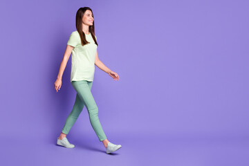 Photo portrait full body view of girl walking forward to blank space isolated on vivid violet colored background