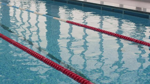 Close up of rippling blue water in indoor pool with lanes