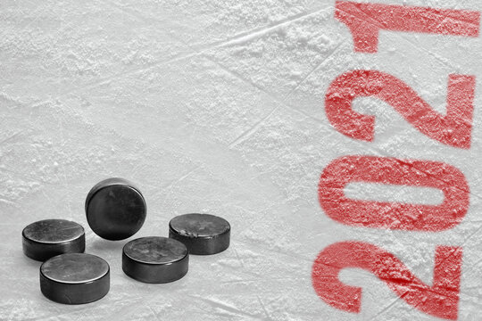 A fragment of the ice rink and ice hockey pucks