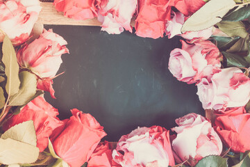 red and pink roses frame on table