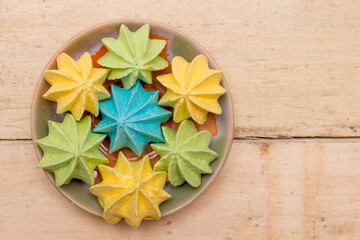 Sweet, crispy, multi-colored meringue in a plate.