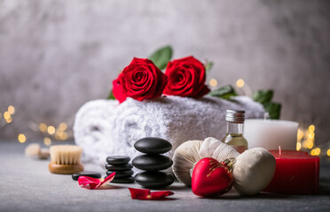 Fototapeta na wymiar Wellness decoration, spa massage setting, oil on stone background. Valentine's Day Zen and relax concept.