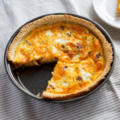 Homemade Bacon Quiche with Eggs and Cheddar Cheese, low angle view.