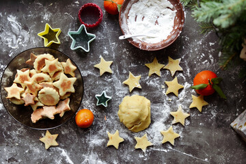 Cooking cookies for the new year and christmas. Flour and dough, cookie cutters. Top view. Copy space